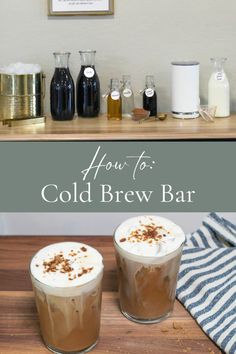 two cold beverages sitting on top of a wooden table next to bottles and glasses filled with liquid