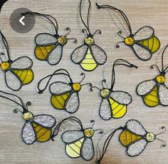 a group of yellow and black butterflies sitting on top of a wooden table