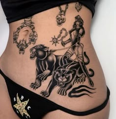 a woman's stomach with tattoos on it and an image of a man riding a lion