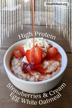 a bowl of oatmeal with strawberries and cream