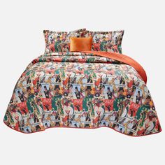 a bed with an orange and green comforter on top of it next to pillows