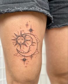 a woman's thigh with a sun and moon tattoo on it