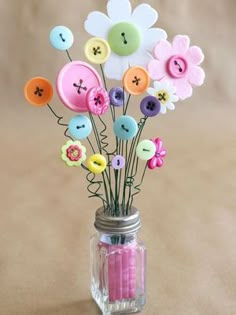 a mason jar filled with buttons and flowers