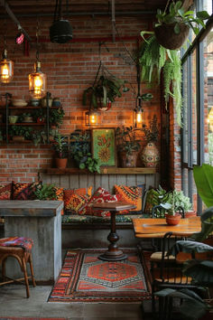 a room filled with lots of potted plants next to a table and two chairs