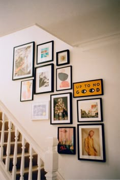 a staircase with many pictures on the wall