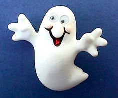 a white plastic ghost with its arms out and eyes wide open on a blue background