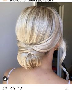 a woman with blonde hair in a low bun