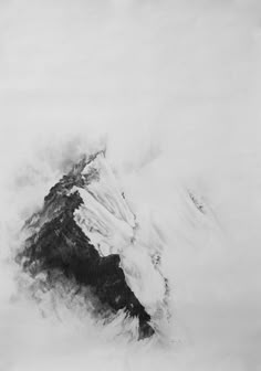 a black and white photo of a mountain in the clouds