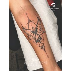 a woman's arm with a bird and arrow tattoo on the left side of her arm