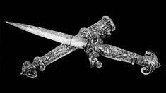 an ornately decorated knife on a black background