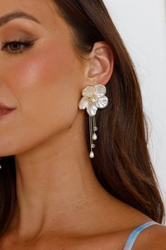 18k gold plated. Polished metal construction. Flower design. Pearlescent finish. Dangle chain with faux pearls and beading. Stud closures for pierced ears. Please Note: Avoid contact with lotions and perfumes. Floral earrings are all the hype at the moment and we can see why. The 18k Gold Plated Florals Of Pearl Earrings feature a statement flower design that has a pearlescent finish and dangly chains. Statement Bridal Earrings, Lotions And Perfumes, Bridal Statement Earrings, Pearl Earrings Gold, Bride Earrings, Bride Jewelry, Gold Pearl Earrings, Satin Maxi, Satin Maxi Dress