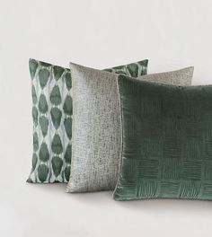 four green and white pillows sitting next to each other