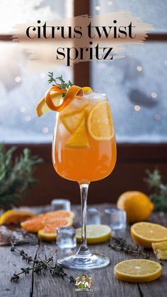 citrus twist spritz in a glass with orange slices and rosemary garnish