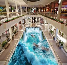 the floor is made to look like an ocean wave with dolphins swimming in it and people walking around