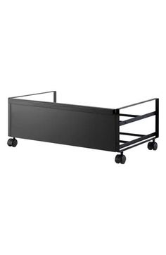 a black metal bed frame with wheels on the bottom, and an open side rail