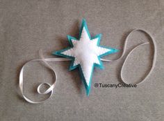 a felt star ornament on a gray surface