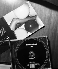 a black and white photo of a cd on a table