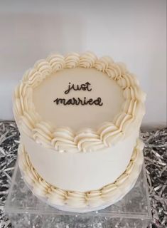 a white cake with the words just married written on it