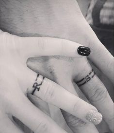 two people with wedding rings on their fingers