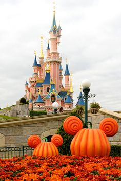 some pumpkins are in front of a castle