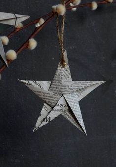 an origami star hanging from a twig