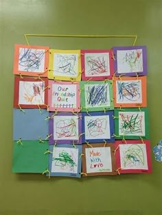 a child's artwork is hung on the wall with clothes pins and paper clippings