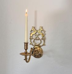 Solid brass vintage double lion wall hanging candle sconce, very unique design, heavy quality, stamped on back with maker. Wall sconces add the most soft ambient glow to any space.  Beautiful vintage condition, holds a standard taper candle. Medium form, perfect accent brass sconce for any room.  approximately 10" tall  5.5" widest point  9" deep from wall Wall Candle Sconces Gold, Brass Candelabra Wall, Vintage Wall Candle Holders, Vintage Wall Candle Sconces, Brass Candle Sconces Vintage, Hanging Candle Holder, Hanging Candles, Candle Sconces, Taper Candle