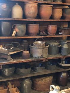 many pots and pans on shelves in a room