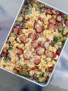 a square tray filled with lots of different types of food on top of a table