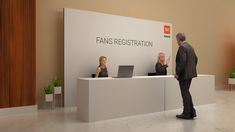 two people standing in front of a reception desk