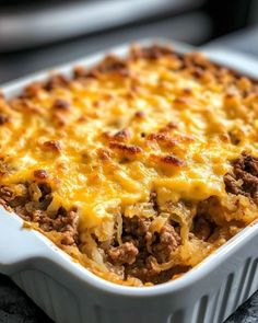 a casserole dish with meat and cheese in it sitting on a counter top