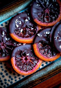 chocolate covered blood oranges on a plate