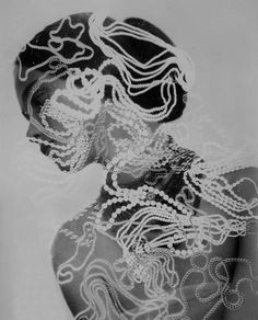 a black and white photo of a woman's face with intricate lace on it