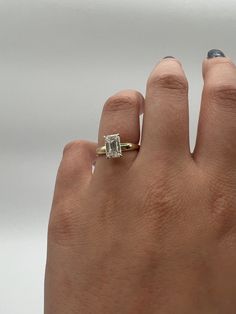 a woman's hand with a diamond ring on it