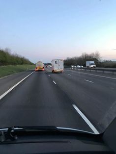 two semi trucks driving down the highway next to each other