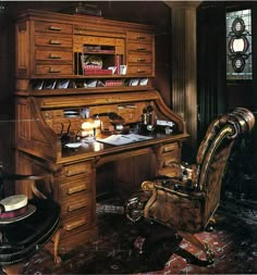 an old fashioned desk and chair in a room