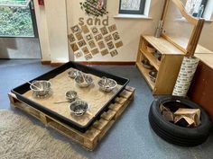 a tray with bowls and spoons sitting on top of it