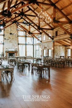 the inside of a building with tables and chairs set up for a wedding or event