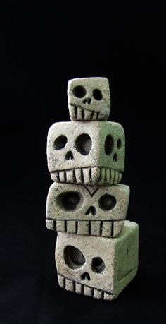 three cement skulls stacked on top of each other