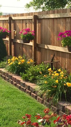 a wooden fence with flowers growing on it