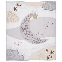 a white blanket with stars and moon on the top, in grey and white colors