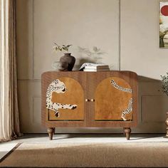 a living room with a wooden cabinet decorated with leopards