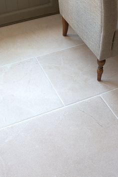 a couch sitting on top of a white tile floor