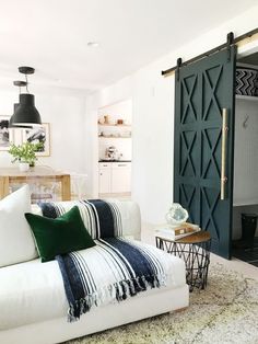 a living room filled with furniture and a sliding door