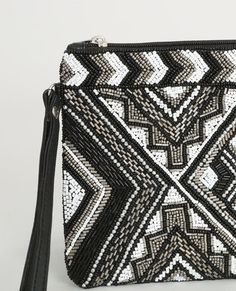 black and white beaded clutch bag with tassels on the front, zippered closure