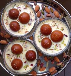 four desserts with nuts and almonds on a metal tray, ready to be eaten