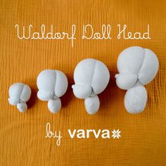 three white stuffed animals sitting next to each other on a wooden surface with the words waddler ball head by varva