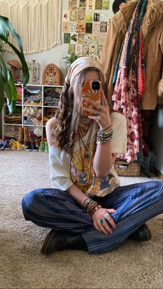 a woman sitting on the floor with her face painted