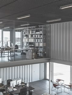 an open office with lots of desks and chairs in it's center area