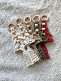 a group of wooden beads and tassels on top of a white cloth covered surface